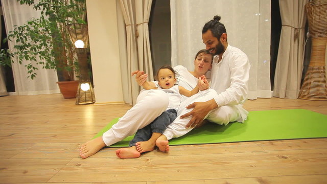 Couple with baby in yoga centre