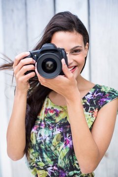 Smiling beautiful brunette taking pictures