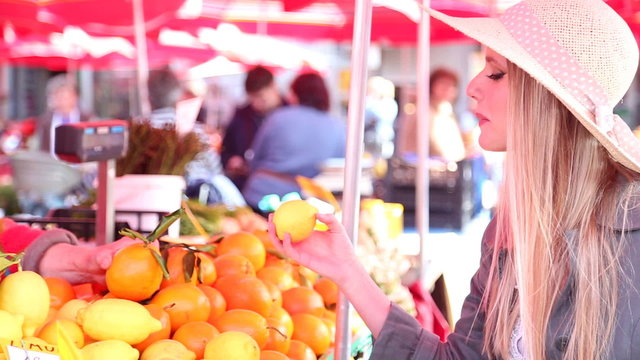 Blonde Girl At The Market Picking Fruit