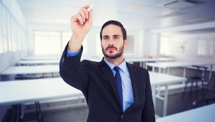 businessman holding a chalk and writing something