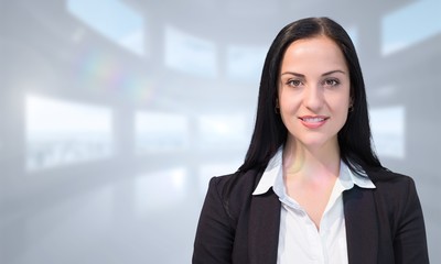 Composite image of pretty businesswoman smiling at camera