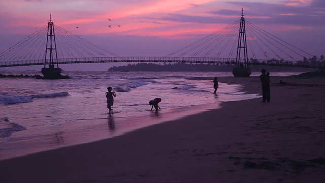 MATARA, SRI LANKA - MARCH 2014: View of people in front of suspension bridge linking pigeon island to Matara.