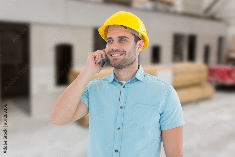 Poster happy architect conversing on mobile phone