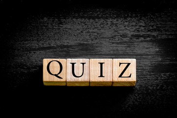 Word QUIZ isolated on black background with copy space