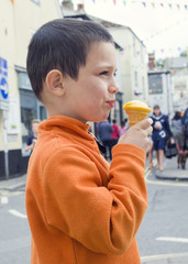 Child eating ice cream at street in Engalnd