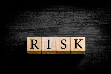 Word RISK  isolated on black background with copy space