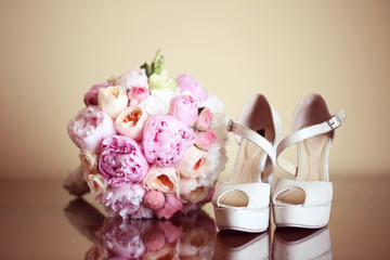 Wedding shoes and peonies bouquet