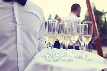 Waiter with glasses of champagne