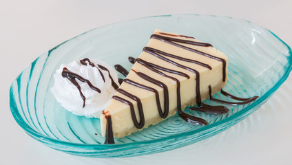 cheese cake and wip cream with chocolate sauce