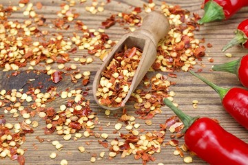Hot Chili Peppers, Milled  Peppers Flakes On Wooden Board