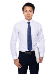 Young businessman holding laptop