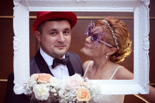 Funny bride and groom in a white frame