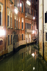 Night channel with old buildings in Venice