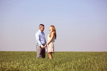 Young couple in green fields