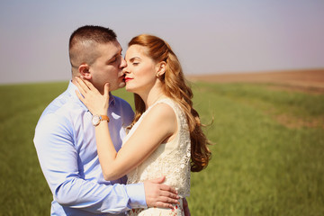 Couple kissing in the fields