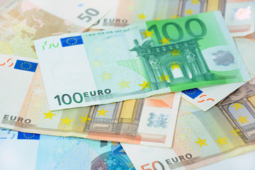 Money - Euro currency with 100 bill on top