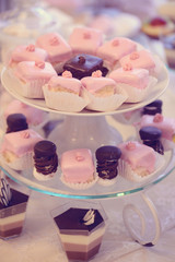 Delicious cakes on rounded plate