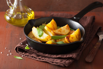 baked potato wedges in black frying pan