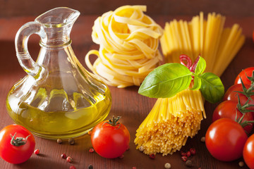 raw pasta olive oil tomatoes. italian cuisine in rustic kitchen