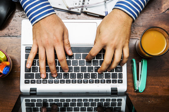 hands on the keyboard of a laptop on the desk work