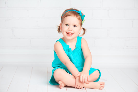 beautiful little baby girl in a turquoise dress