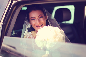 Bride laughing in the car