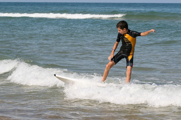 young teen boy learning how to surf