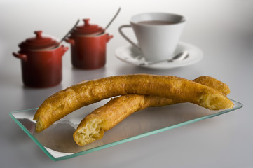 Spanish typical fried porras with a cup of hot chocolat