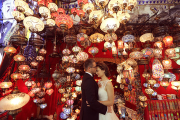 Bride and groom surrounded by turkish lamps