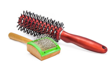 Comb for cats on a background of hair brushes
