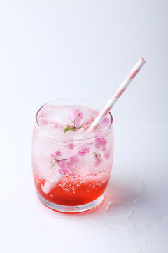 Fresh pink flower frozen in ice cubes for summer drinks