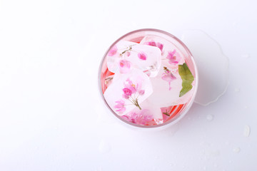 pink flowers ice cube in glass,top view