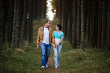 Happy couple in a pine forest