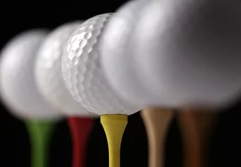 Foto op Plexiglas Several golf balls on tees, one in focus © justasc