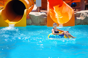 Beautiful girl riding a water slide