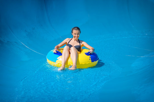 Beautiful Girl Riding A Water Slide