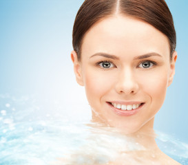 face of beautiful young woman and water splash