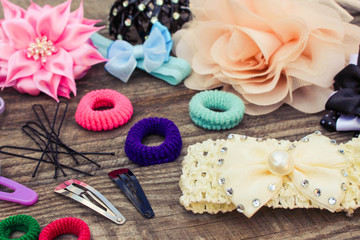 Different hair clips on wooden background