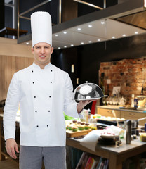 happy male chef cook holding cloche