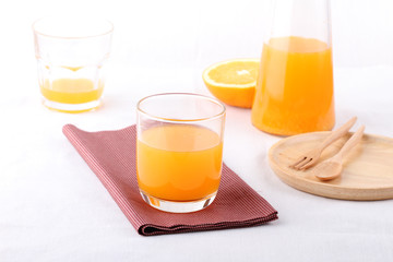 glass of orange juice and a bottle of orange juice