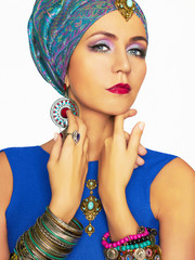 rich beautiful woman in turban and jewelry.
