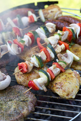 barbecue with delicious grilled meat and vegetables on grill