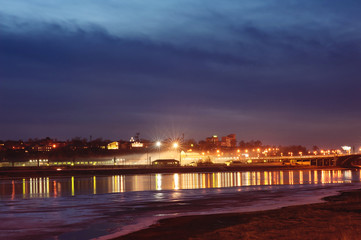 Night industrial city reflected in the river. Irkutsk.