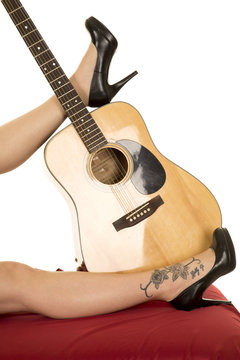 woman legs with tattoo on foot with guitar