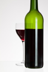 Wine glass and bottle with red wine