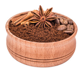 ground coffee in a wooden bowl isolated on white background