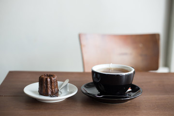 brown sweet canele and hot tea