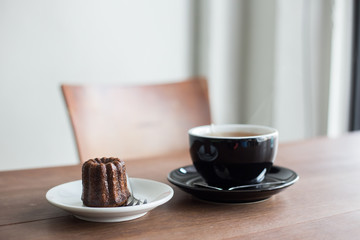 brown sweet canele and hot tea