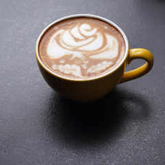 Cup of cappuccino on dark background