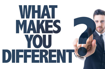 Business man pointing the text: What Makes You Different?